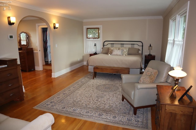 bedroom with light wood-type flooring and ornamental molding