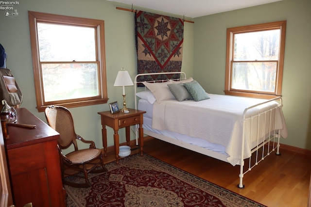 bedroom featuring hardwood / wood-style floors and multiple windows