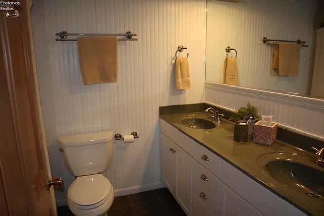 bathroom with tile patterned flooring, vanity, and toilet