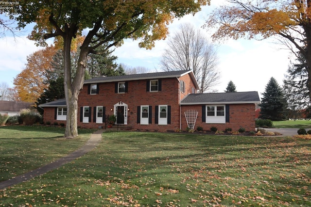 colonial-style house with a front yard