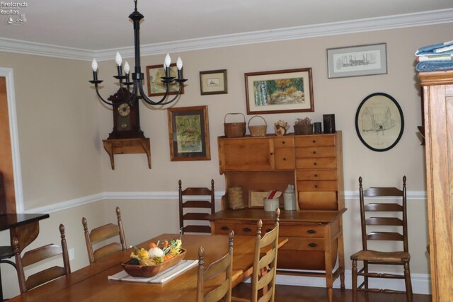 dining space featuring ornamental molding and an inviting chandelier