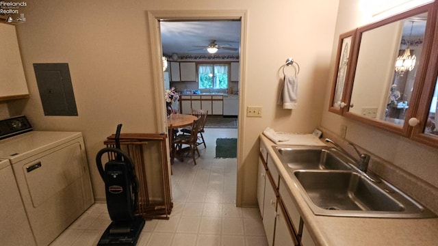 laundry area with electric panel, ceiling fan, sink, and washer / clothes dryer