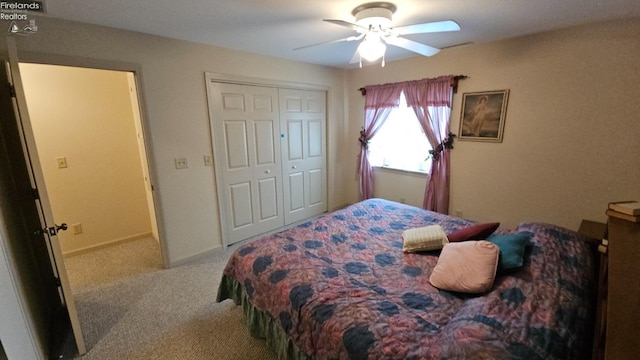 carpeted bedroom with a closet and ceiling fan