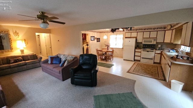 living room with ceiling fan and sink