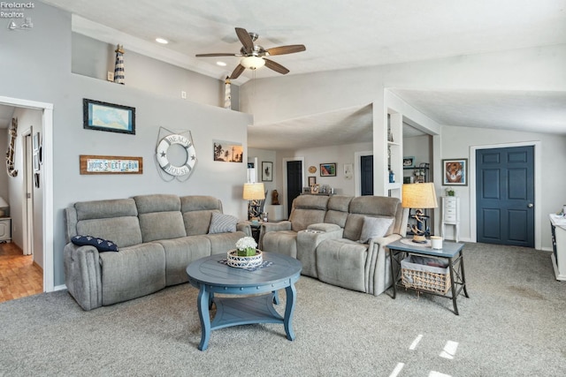 living room featuring vaulted ceiling, ceiling fan, and carpet floors