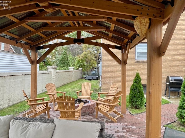 view of patio / terrace featuring a gazebo, a grill, and a fire pit