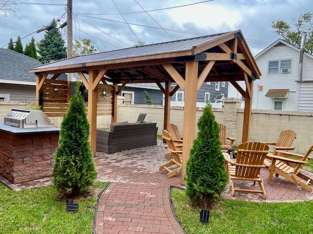 view of patio with a gazebo, an outdoor kitchen, and a grill