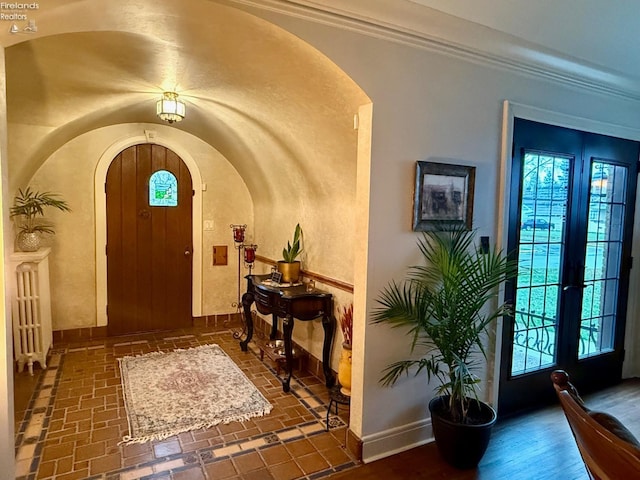 entrance foyer with ornamental molding and french doors