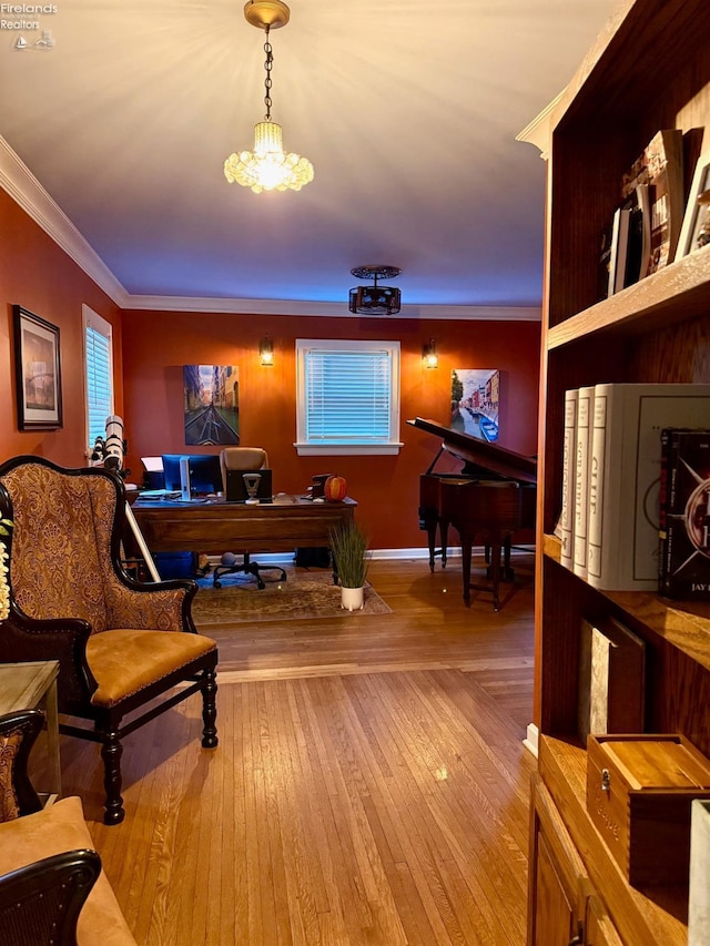 office area featuring hardwood / wood-style floors, crown molding, and a chandelier