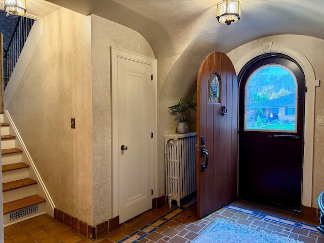 foyer entrance featuring lofted ceiling