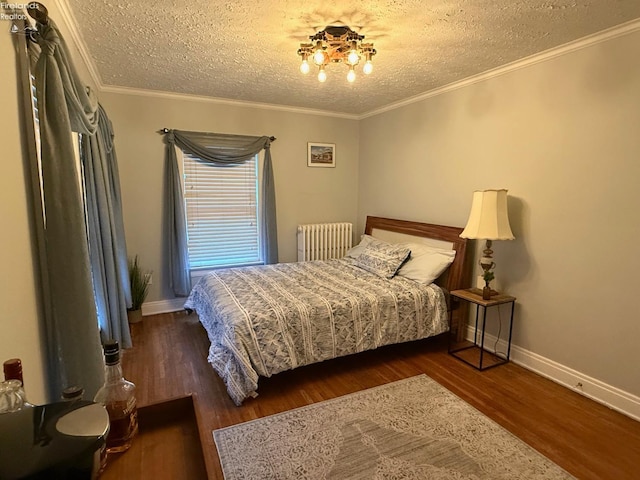 bedroom with a textured ceiling, ornamental molding, dark wood-type flooring, and radiator