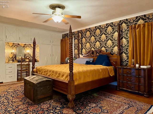 bedroom featuring dark hardwood / wood-style flooring, ceiling fan, and ornamental molding