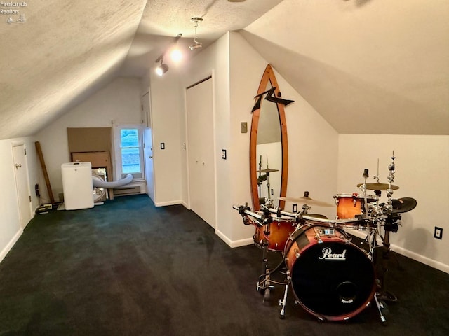 interior space with vaulted ceiling, a textured ceiling, and dark colored carpet