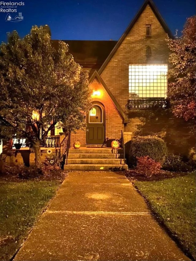 view of exterior entry at twilight