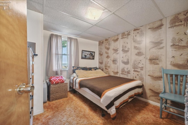 carpeted bedroom featuring a paneled ceiling