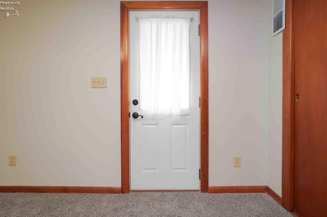 doorway featuring carpet