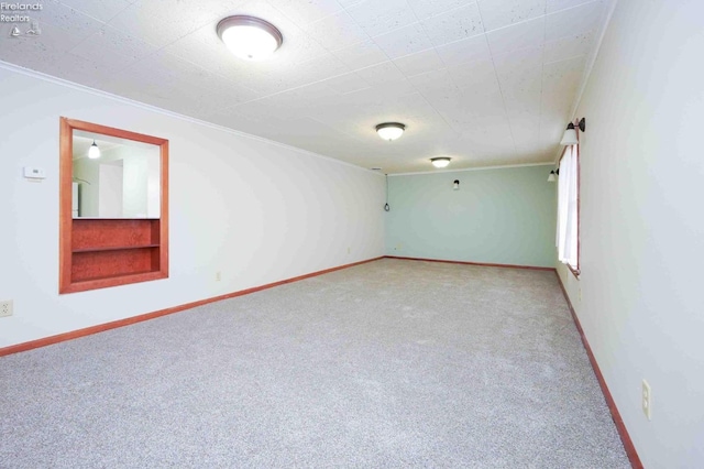 spare room with carpet and ornamental molding