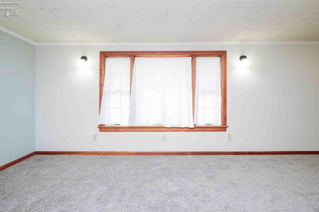 carpeted spare room with ornamental molding