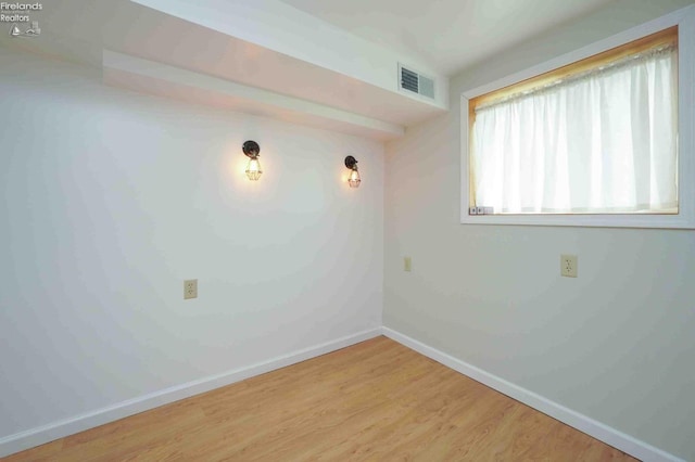 empty room with hardwood / wood-style flooring