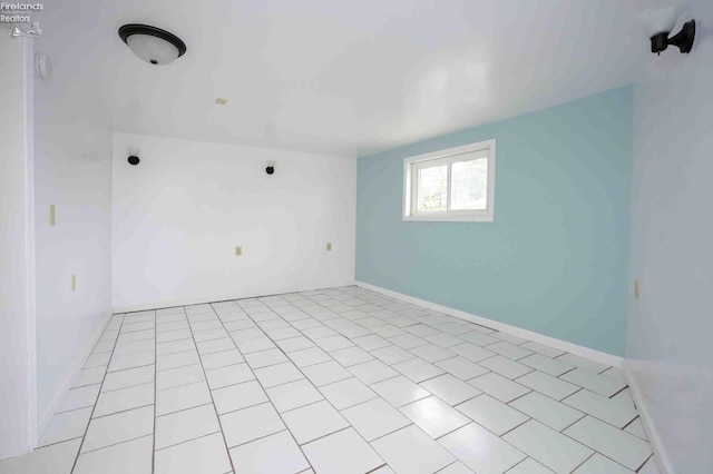 spare room featuring light tile patterned flooring