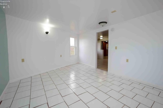 unfurnished room with light tile patterned floors