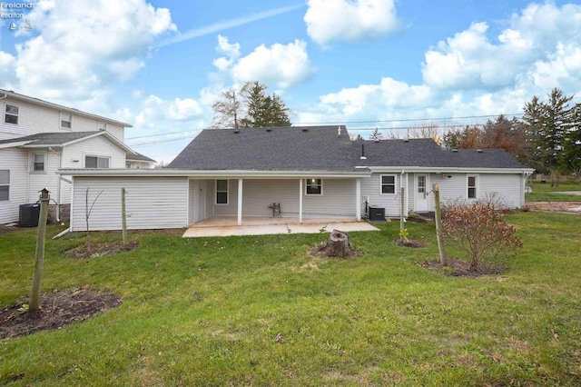 back of house featuring central AC, a yard, and a patio