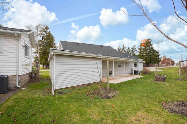 back of house with a lawn, a patio, and central AC