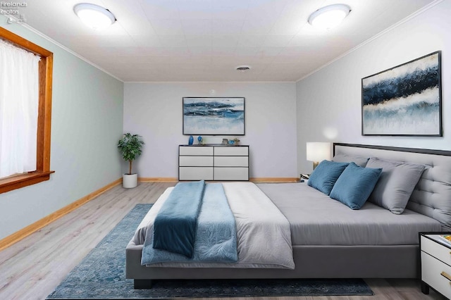 bedroom featuring light hardwood / wood-style floors and ornamental molding