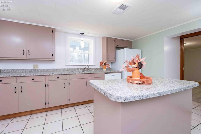 kitchen featuring sink, light tile patterned floors, crown molding, pendant lighting, and a kitchen island