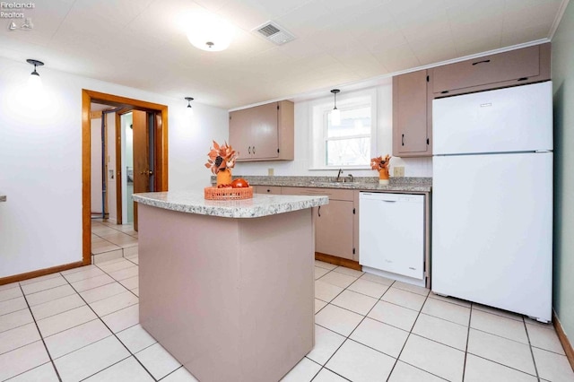 kitchen with sink, light tile patterned floors, hanging light fixtures, and white appliances