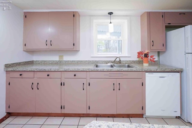 kitchen featuring sink, white dishwasher, light tile patterned flooring, and decorative light fixtures