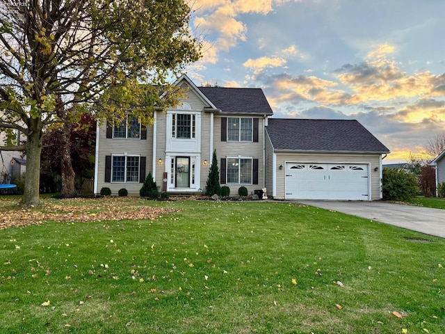 colonial-style house with a garage and a yard