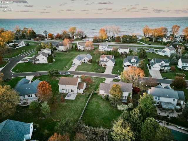 aerial view at dusk with a water view