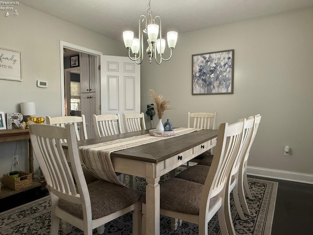 dining space with an inviting chandelier and dark hardwood / wood-style floors