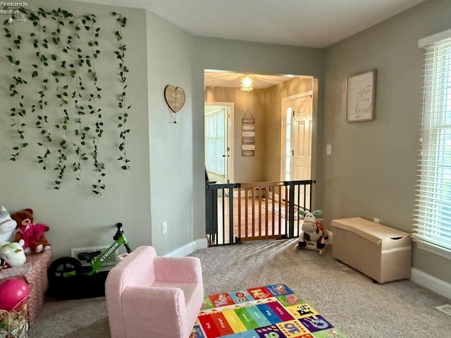 recreation room with carpet flooring and a healthy amount of sunlight