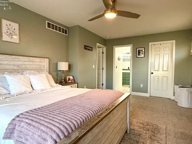 bedroom featuring carpet floors, ceiling fan, and connected bathroom