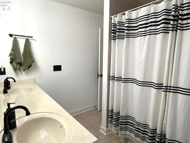 bathroom with vanity, a shower with shower curtain, tile patterned floors, and a textured ceiling