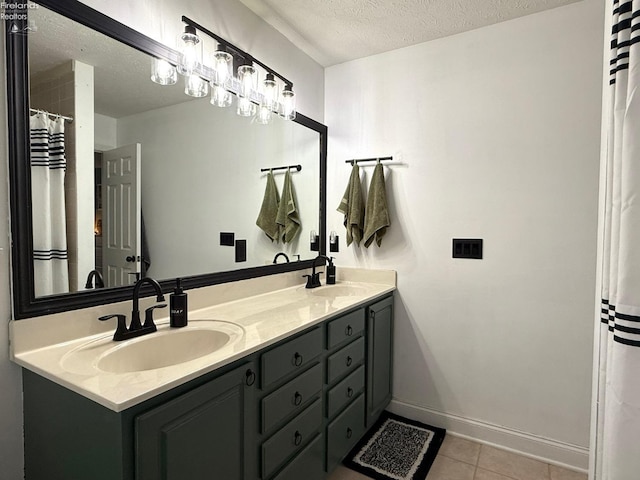 bathroom with vanity, tile patterned flooring, and a textured ceiling