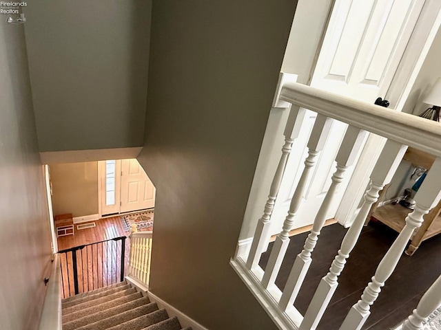 staircase featuring hardwood / wood-style flooring