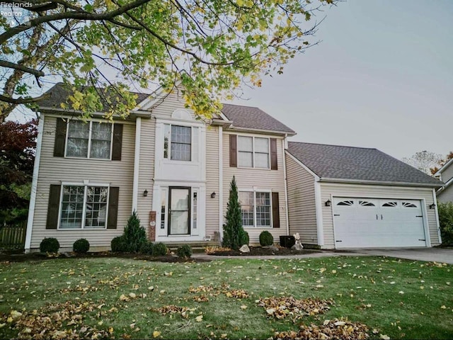 colonial home featuring a garage and a front yard