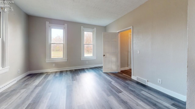 spare room featuring hardwood / wood-style flooring