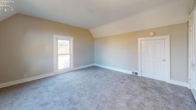 bonus room featuring carpet and lofted ceiling