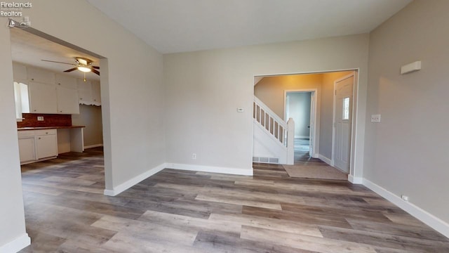 empty room with light hardwood / wood-style flooring and ceiling fan