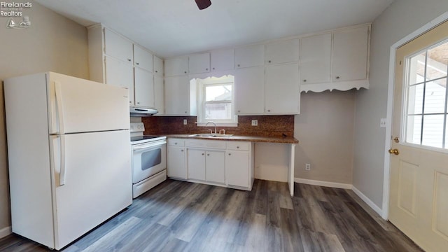 kitchen with white cabinets, white appliances, and a wealth of natural light