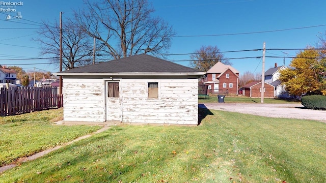 view of outbuilding with a yard