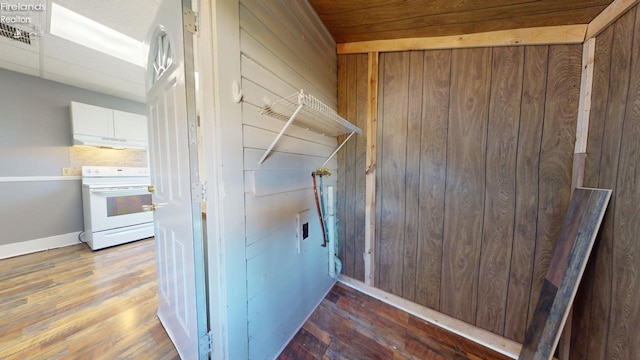 hall with dark hardwood / wood-style floors and wooden walls