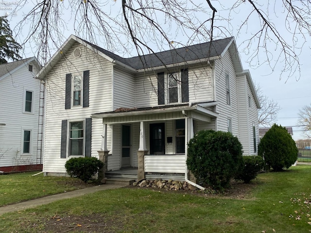 view of front of home featuring a front lawn and covered porch