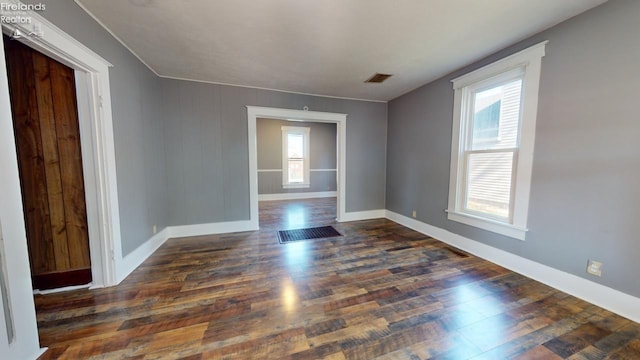 spare room with dark wood-type flooring