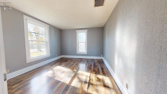 unfurnished room featuring dark hardwood / wood-style flooring