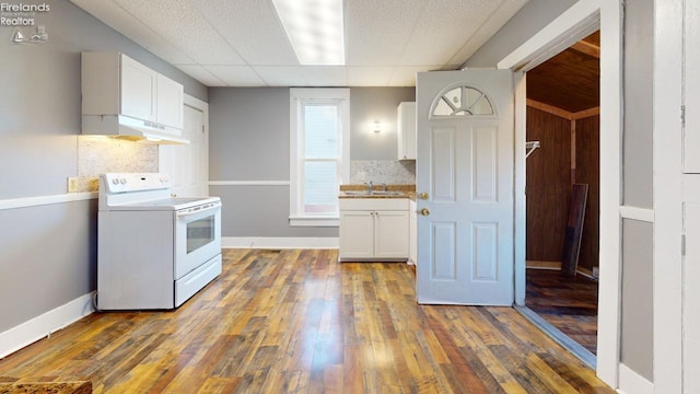 kitchen featuring white cabinets, white electric range, dark wood-type flooring, and sink
